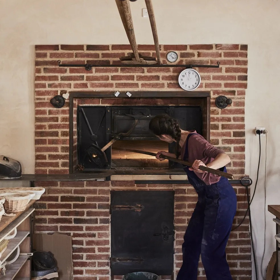 Boulangère de la boulangerie Vagabonde enfournant du pain